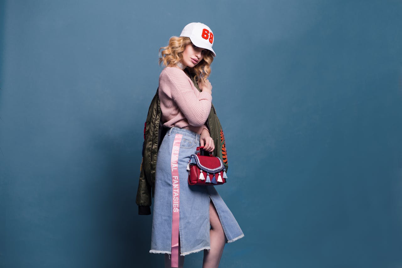 About Trendy fashion model poses in a stylish studio setting, showcasing a chic outfit with accessories.
